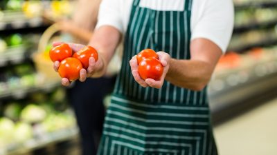 mid-section-of-worker-showing-vegetables-in-supermarket.jpg mid-section-of-worker-showing-vegetables-in-supermarket.jpg